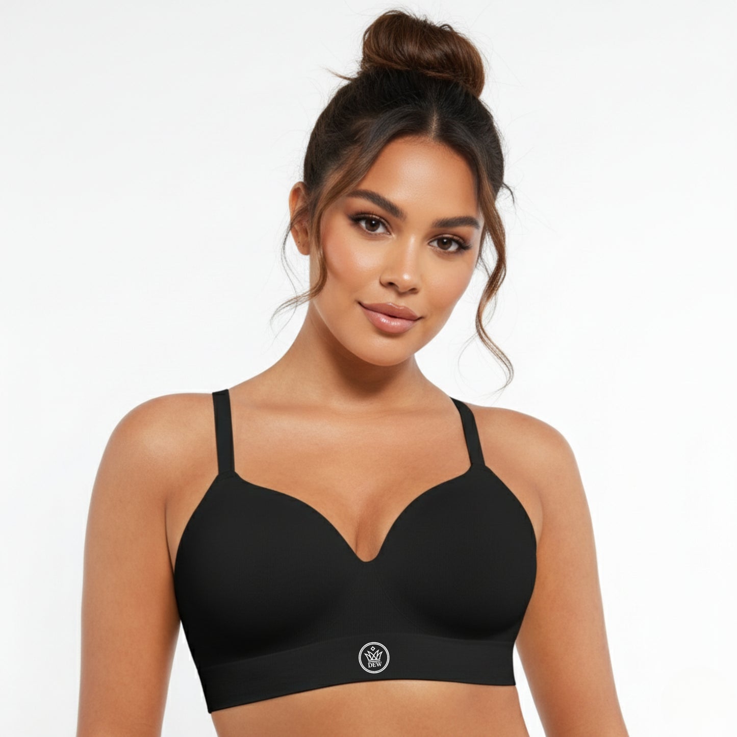 Woman wearing a black DEW Seamless Sculpt Bra on a plain background