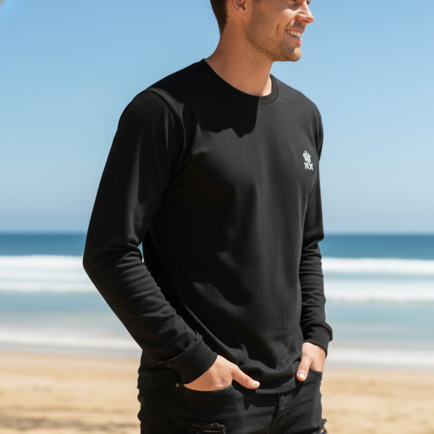 Man wearing a Dew 100% Cotton black tshirt with a logo on a beach