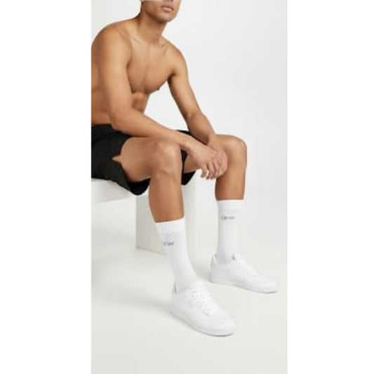 Unisex white crew socks with DEW logo on model. Casual activewear fit