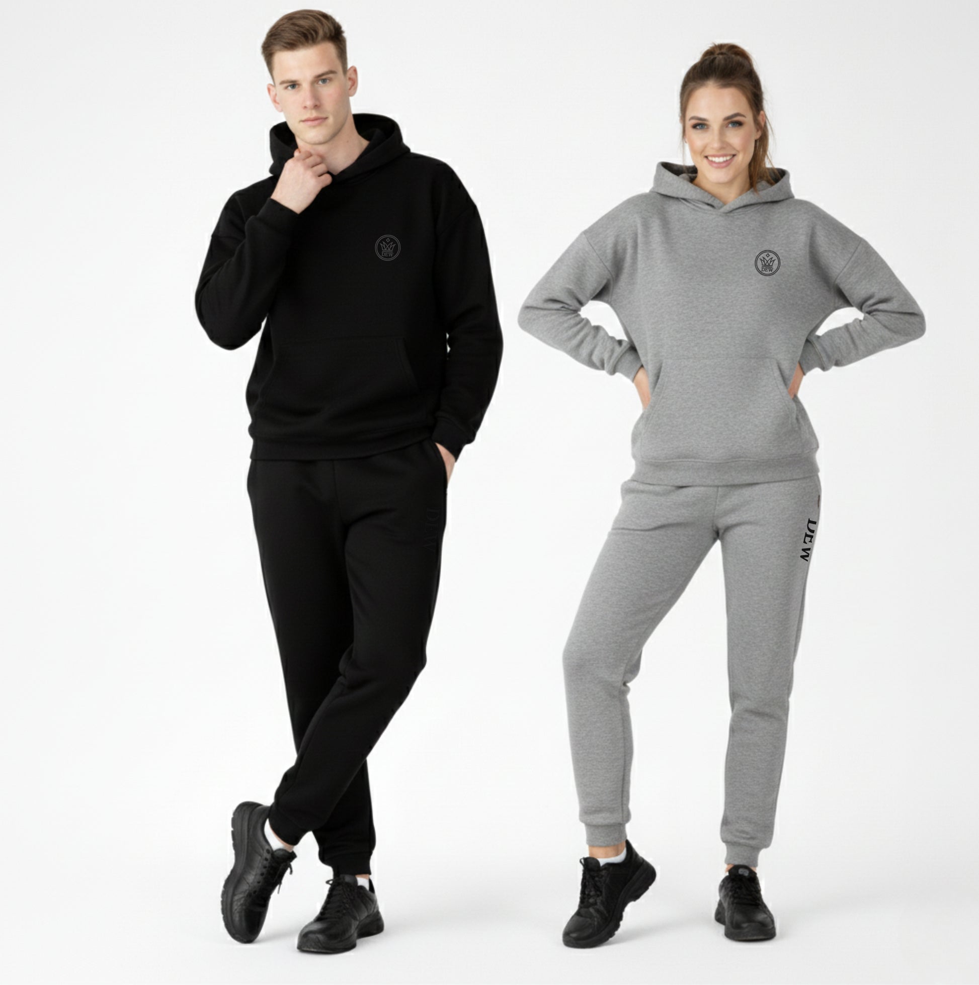 Man and woman wearing black and gray tracksuits with a logo on a white background