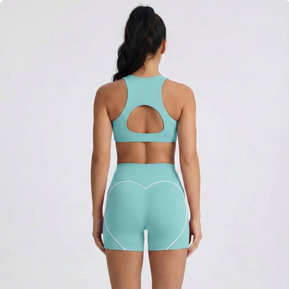 Person wearing a Dew mint sports bra and dew curve shorts set on a white background
