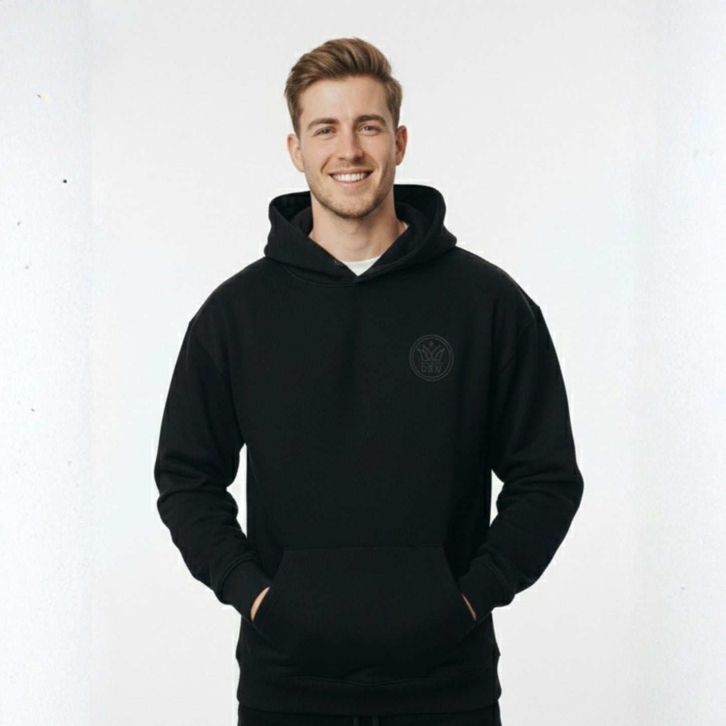 Man wearing a black hoodie with a logo on a white background