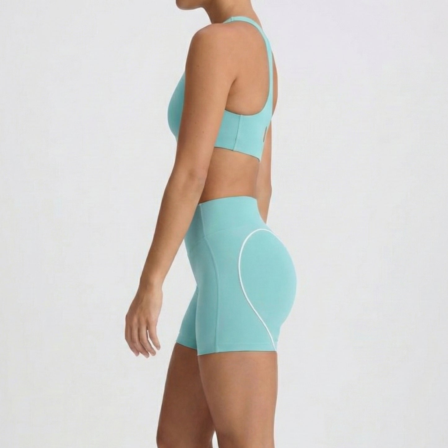 Side profile of squat proof mint workout shorts and matching sports bra by DEW Active Australia