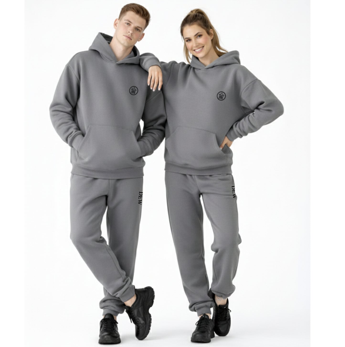 smiling models wearing grey dew oversized unisex hoodies joggers set