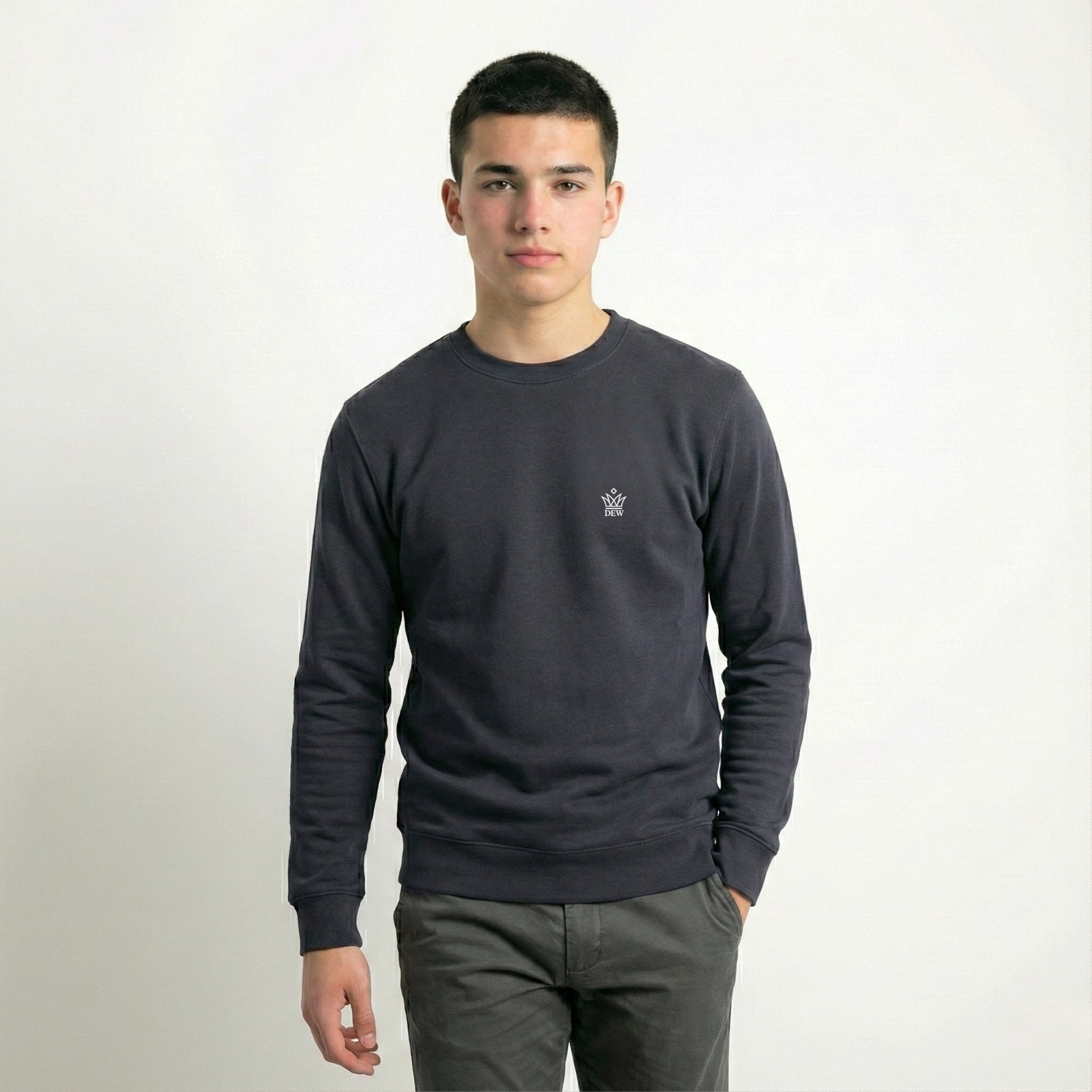 Man wearing a dark gray long-sleeve shirt with a small logo on a white background