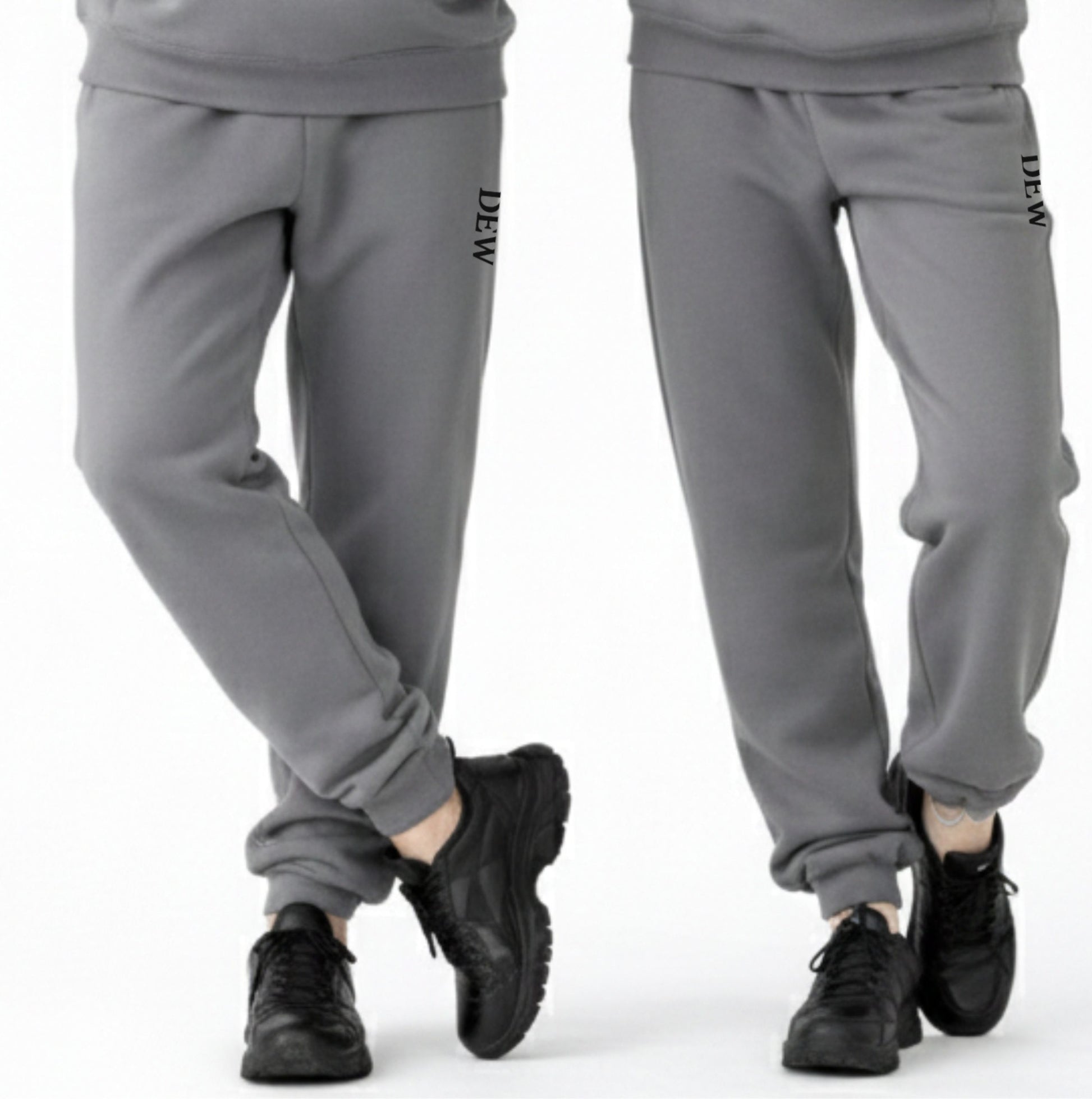 Gray sweatpants with brand logo worn by a person on a white background