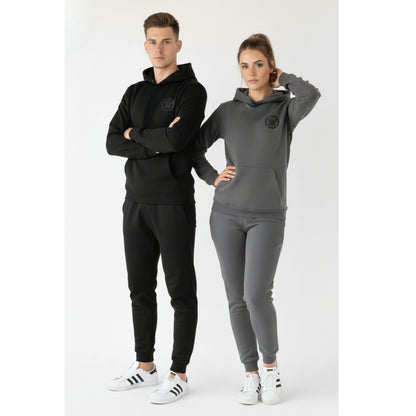 Two people wearing black and gray tracksuits with a brand logo on a white background