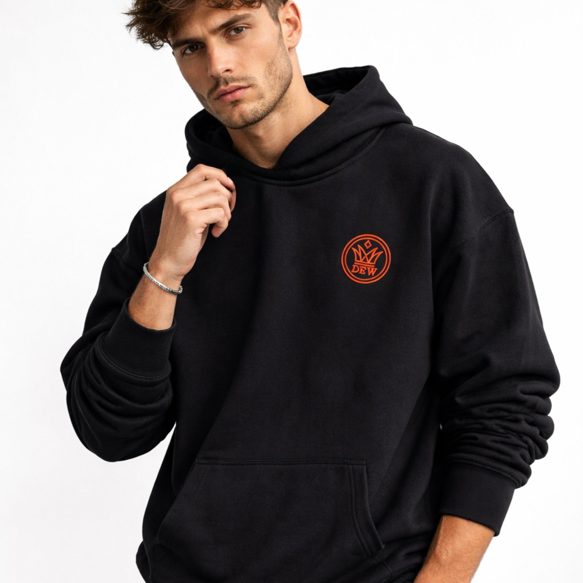 Man wearing a black hoodie with a red logo on a white background