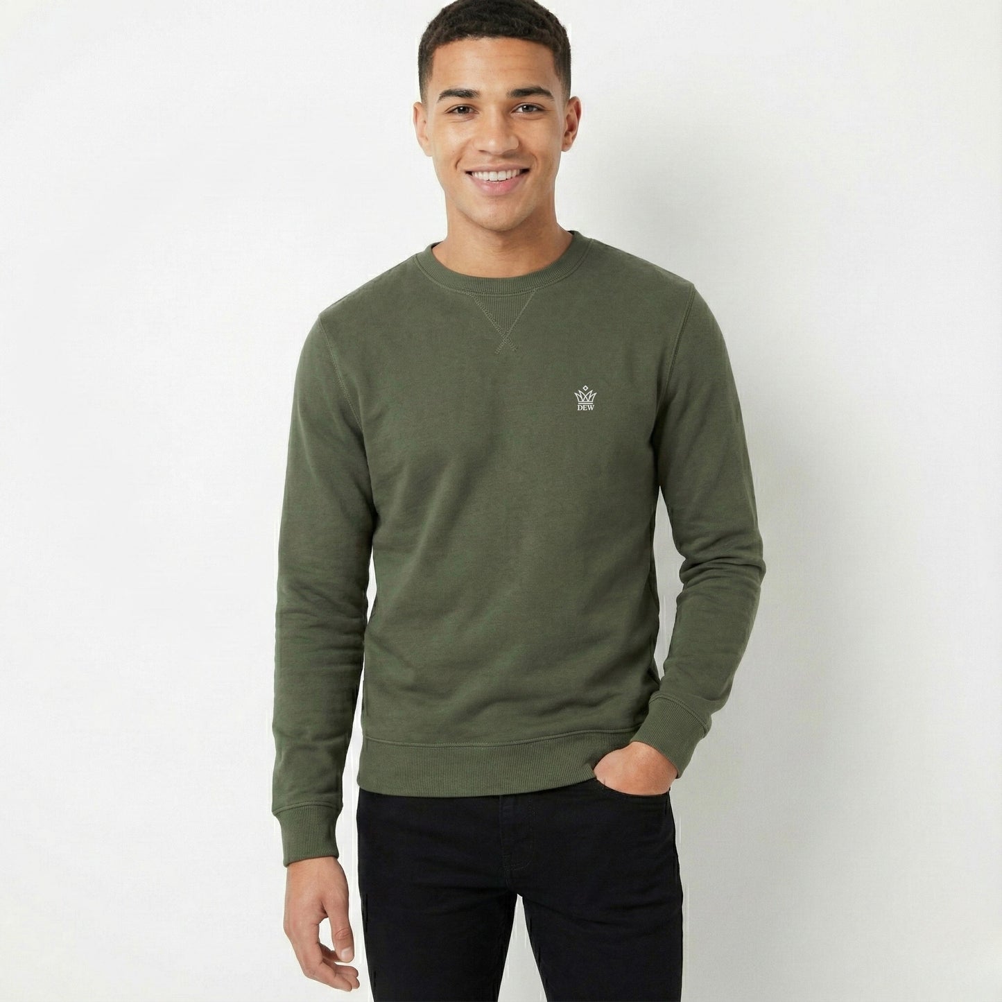 Man wearing a green sweatshirt with a small logo on a white background