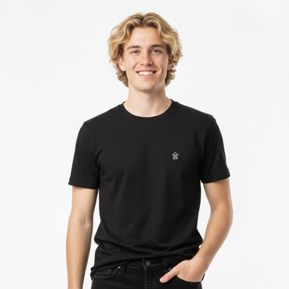 Man wearing a DEW 100% Cotton black t-shirt with a small logo on a white background