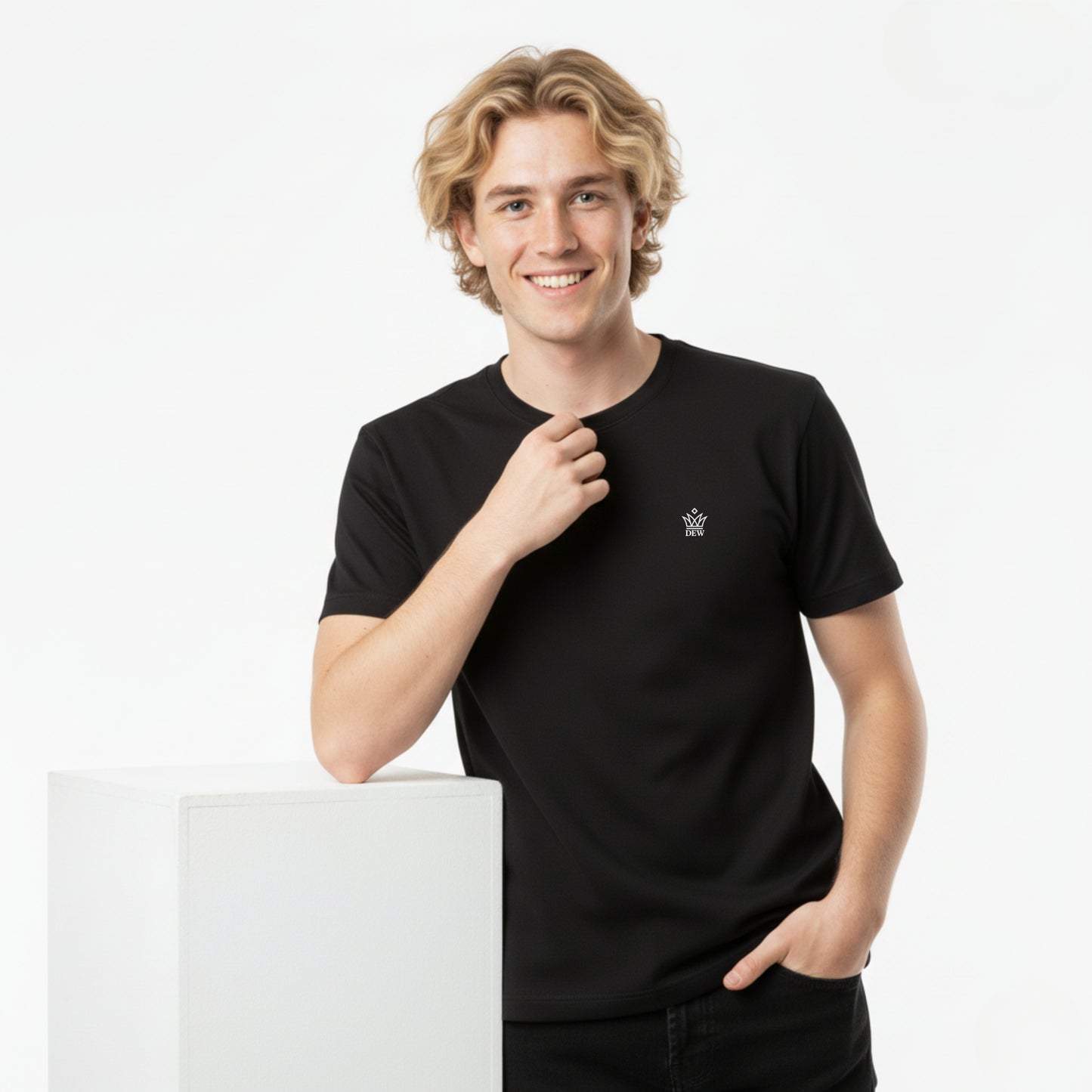 Man wearing a DEW 100% Cotton black t-shirt  with a small embroidered Dew embroidered logo on a white background