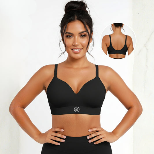 Woman wearing a black DEW Seamless Sculpt Bra with a visible Dew brand logo, standing against a white background.