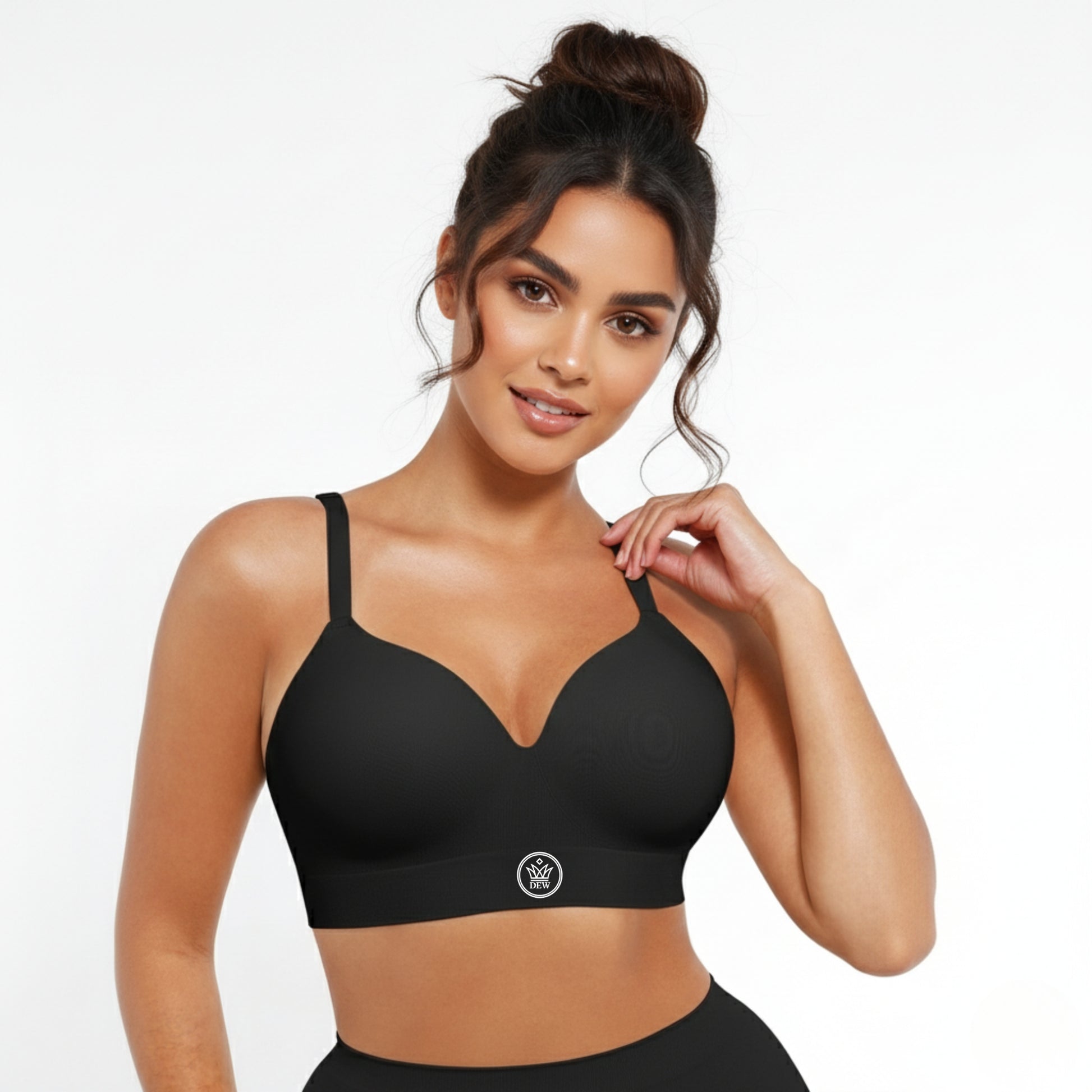 Woman wearing a black DEW Seamless Sculpt Bra with a visible brand logo on a white background