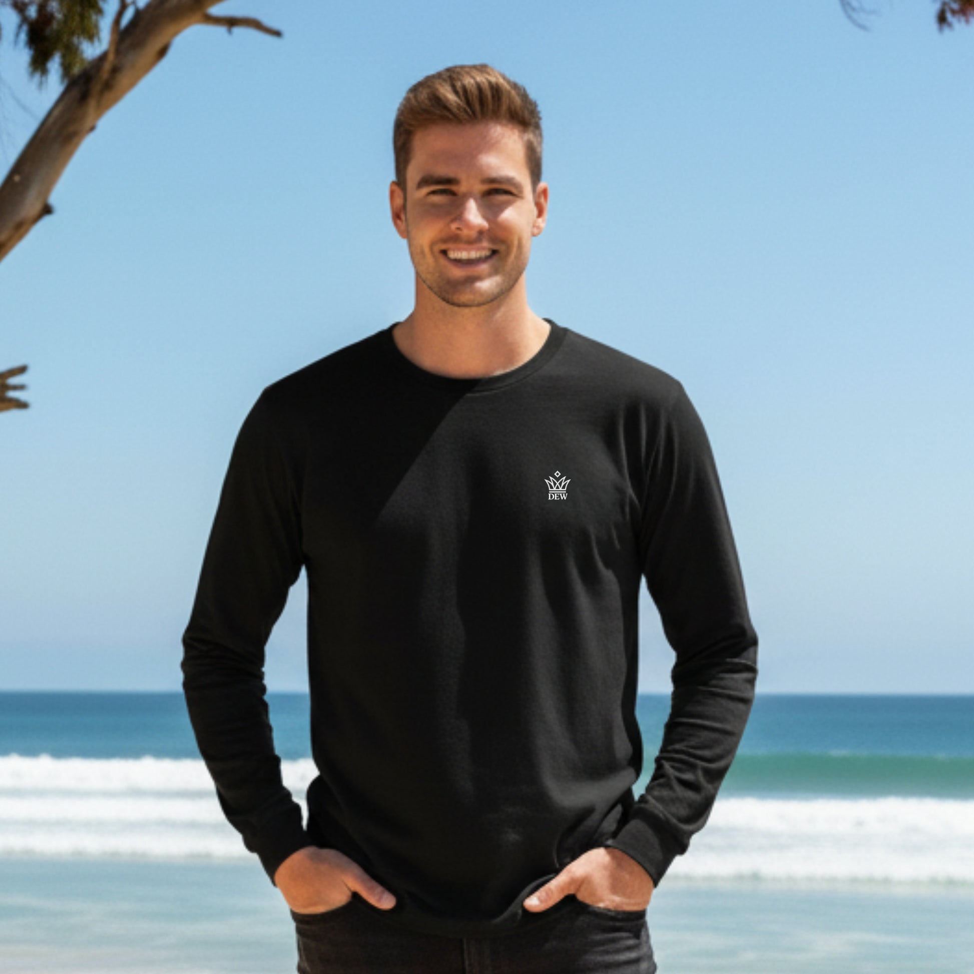 Man wearing a  Dew 100% Cotton black long-sleeve shirt with a logo on a beach