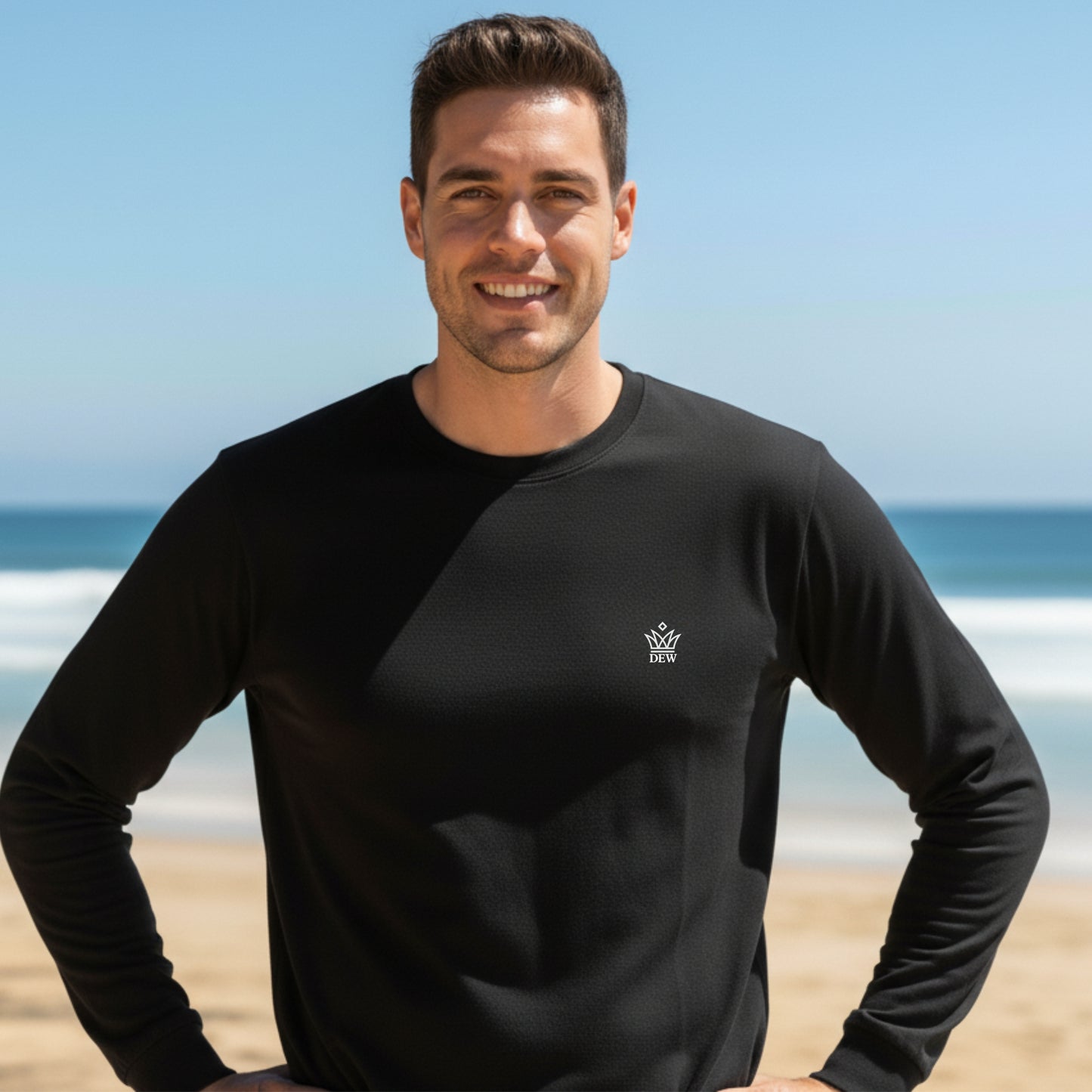 Man wearing a  Dew 100% Cotton black long-sleeve shirt with a logo on a beach