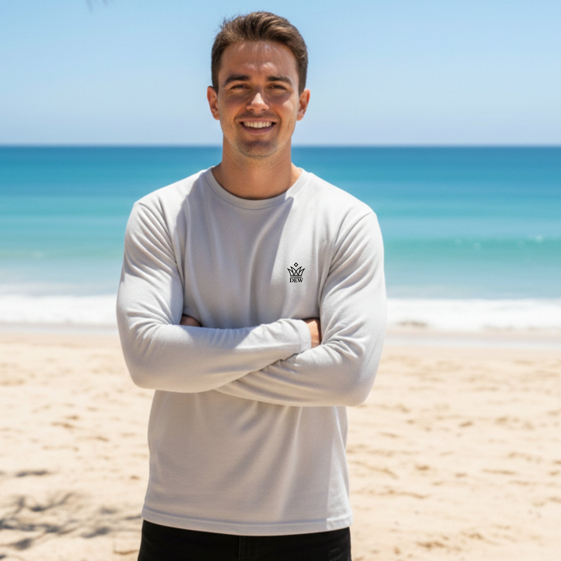 Man wearing a Dew 100 % cotton white long-sleeve shirt with a logo on a beach