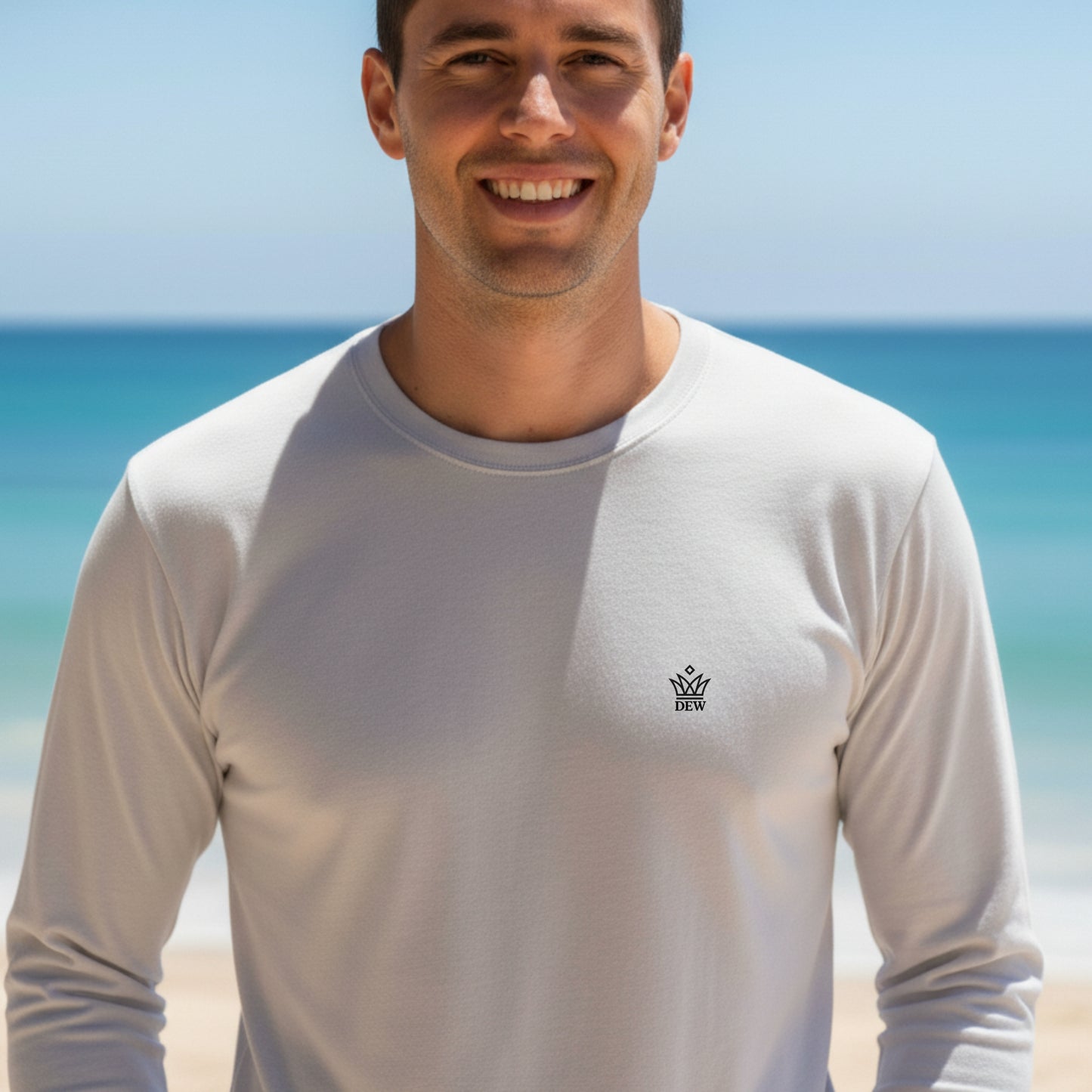 Man wearing a Dew 100 % cotton sea gray long-sleeve shirt with a logo on a beach