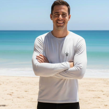 Man wearing a Dew 100 % cotton white long-sleeve shirt with a logo on a beach