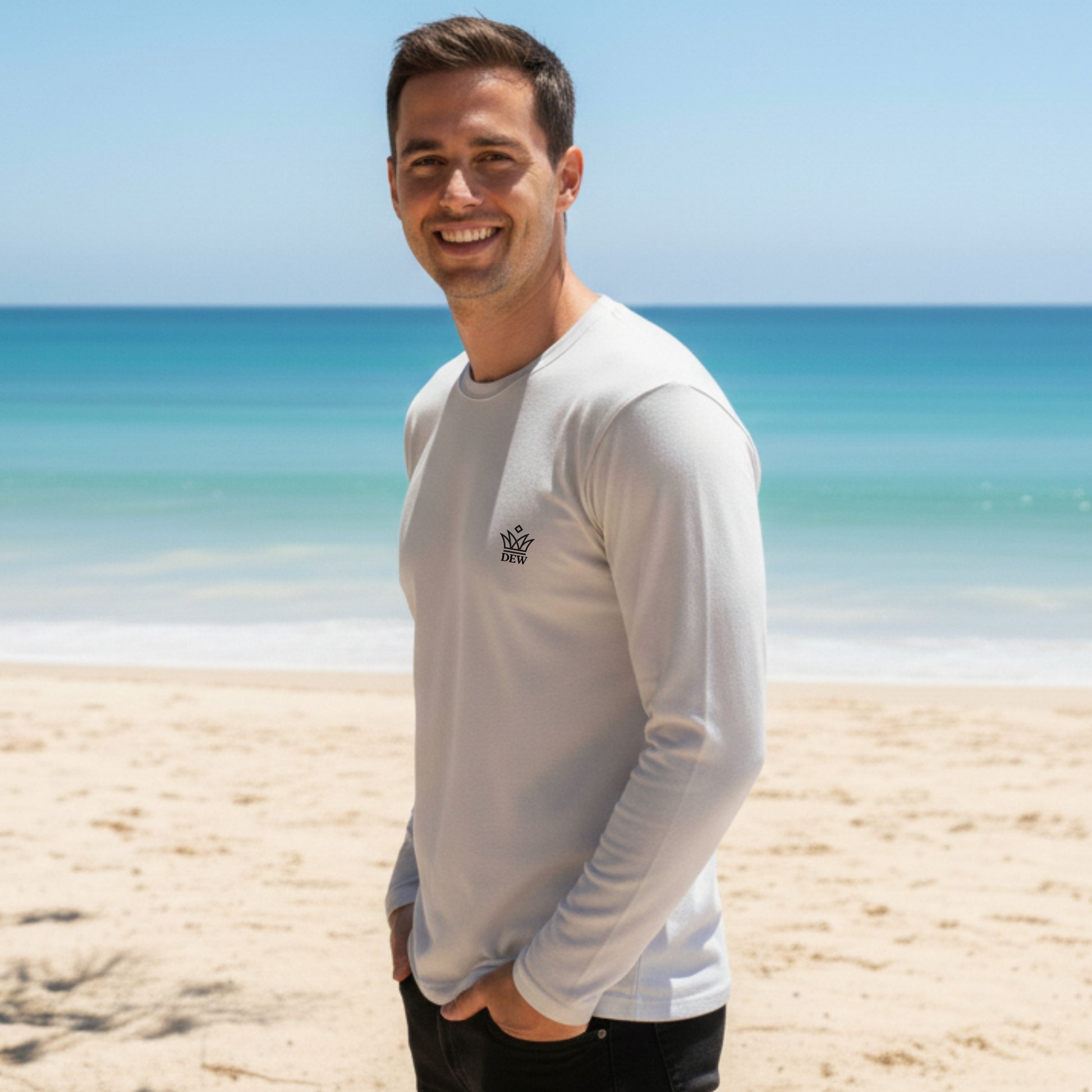 Man wearing a Dew 100 % cotton sea gray long-sleeve shirt with a logo on a beach