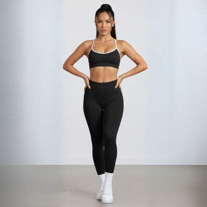Woman wearing a DEW Elevate Bra and leggings with white sneakers on a light gray background