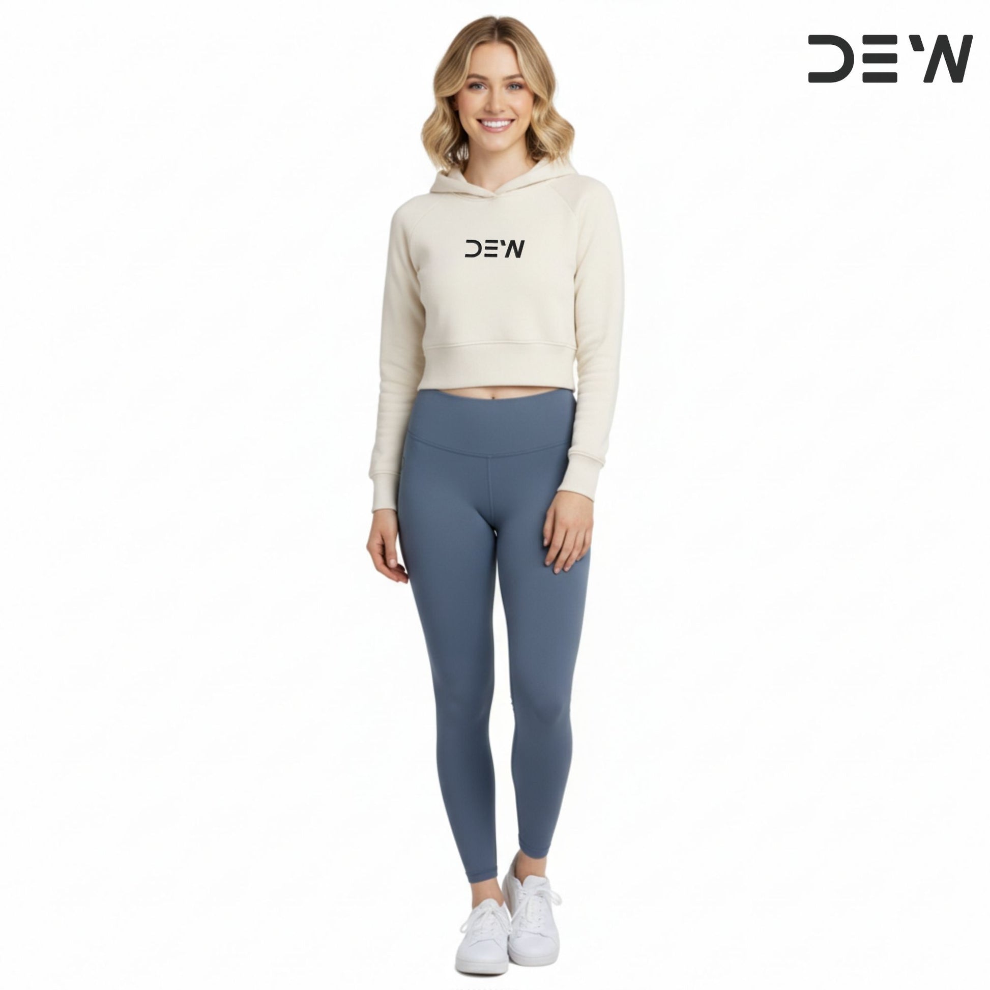 Woman wearing a beige hoodie and Dew Core fit high waited leggings ocean mist with 'DEW' branding on a white background