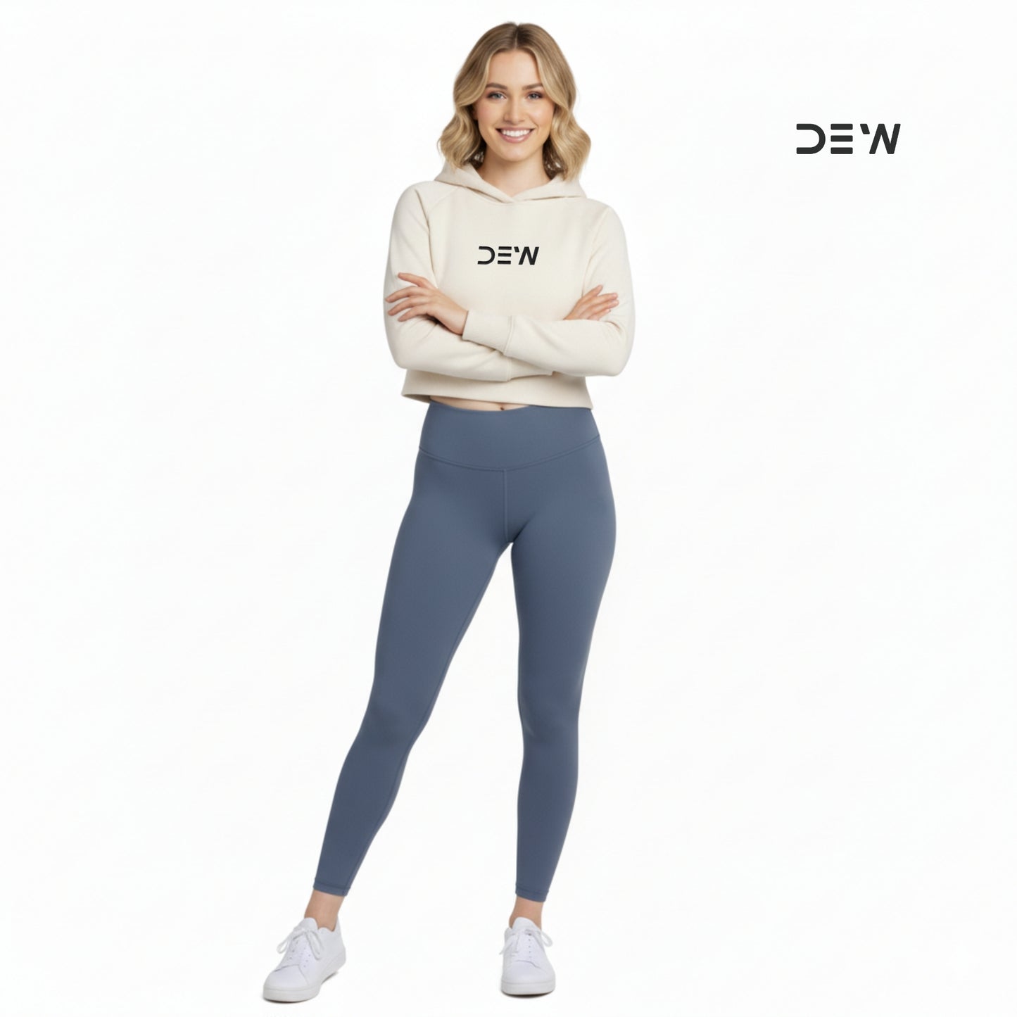 Woman wearing a beige hoodie and Dew Core fit high waited leggings ocean mist with 'DEW' branding on a white background