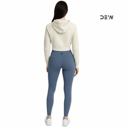 Person wearing a white hoodie and Dew Core fit high waited leggings ocean mist  on a white background with 'DEW' branding.