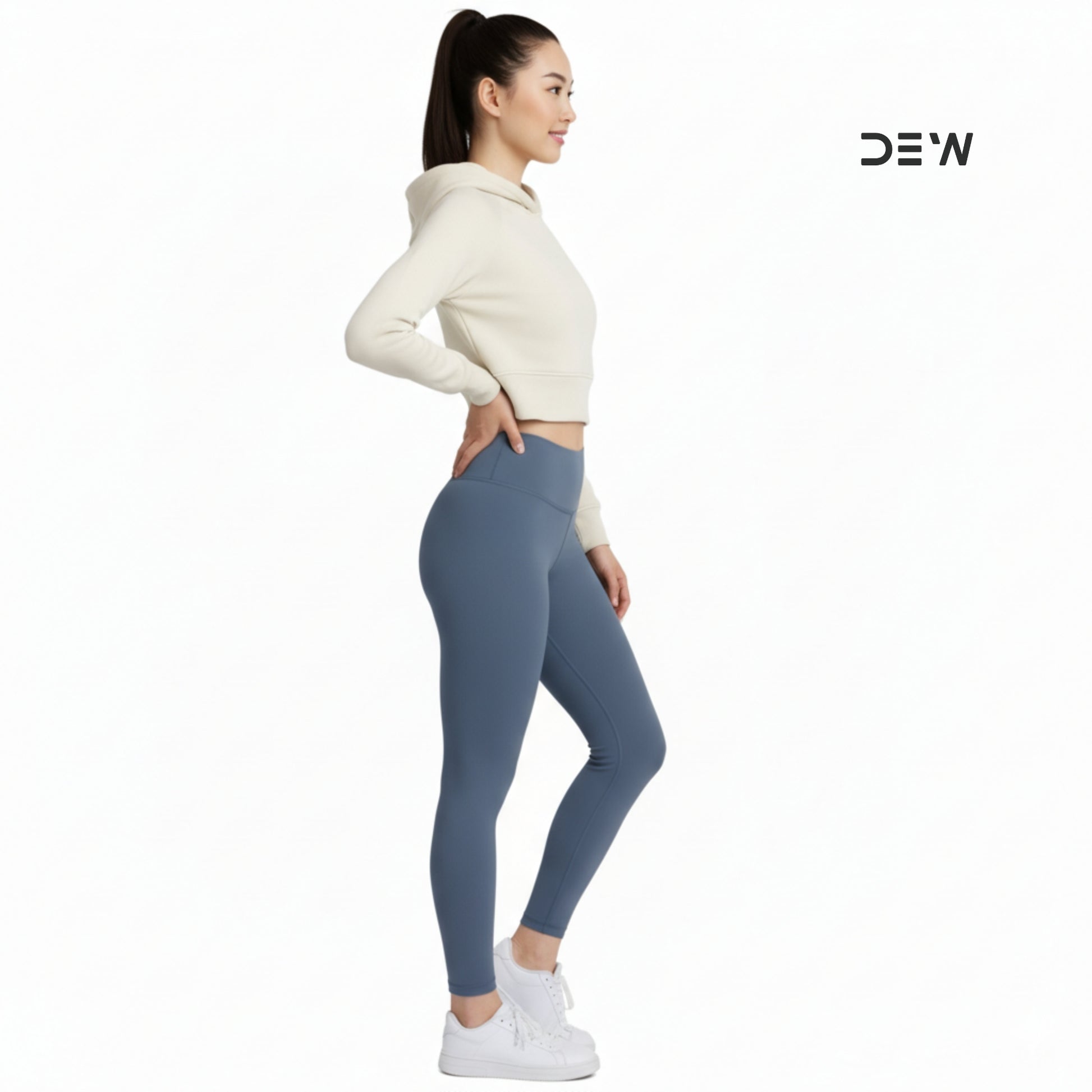 Woman wearing a cream hoodie and Dew Core fit high waited leggings ocean mist  on a white background with 'DEW' branding.