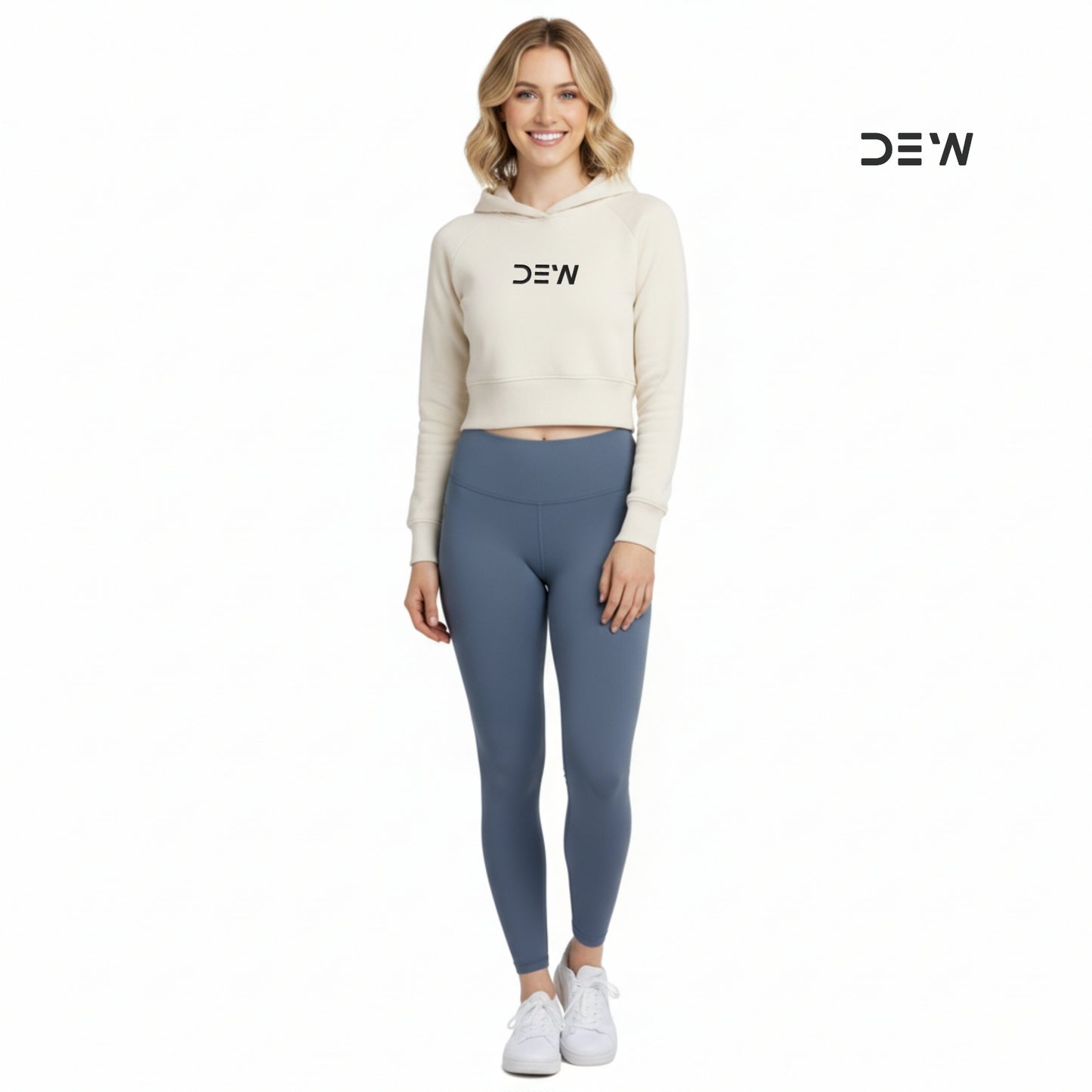 Woman wearing a beige hoodie and Dew ocean mist leggings with 'DEW' branding on a white background