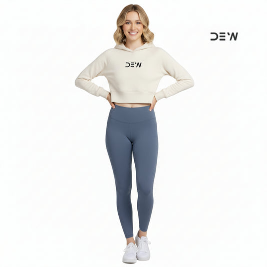Woman wearing a white hoodie and Dew Core fit leggings ocean mist with 'DEW' branding on a white background