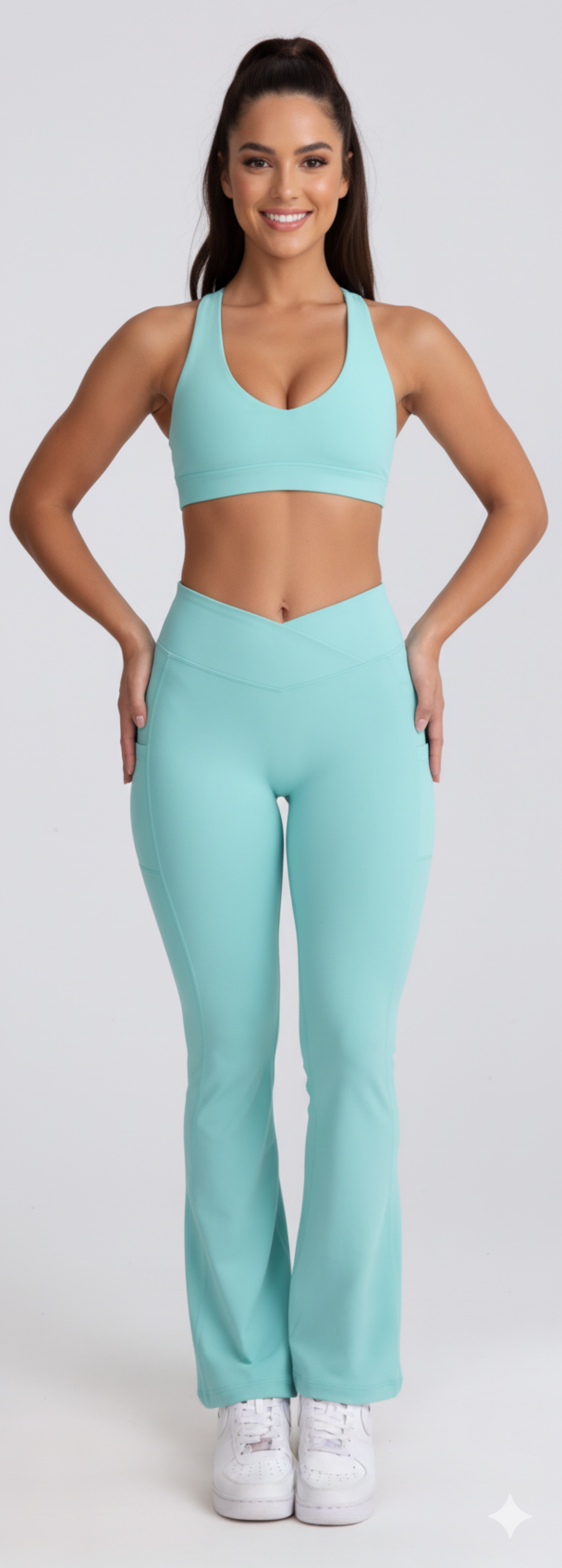 Woman wearing a matching Dew Flow fit flares in mint sports bra and leggings set on a white background