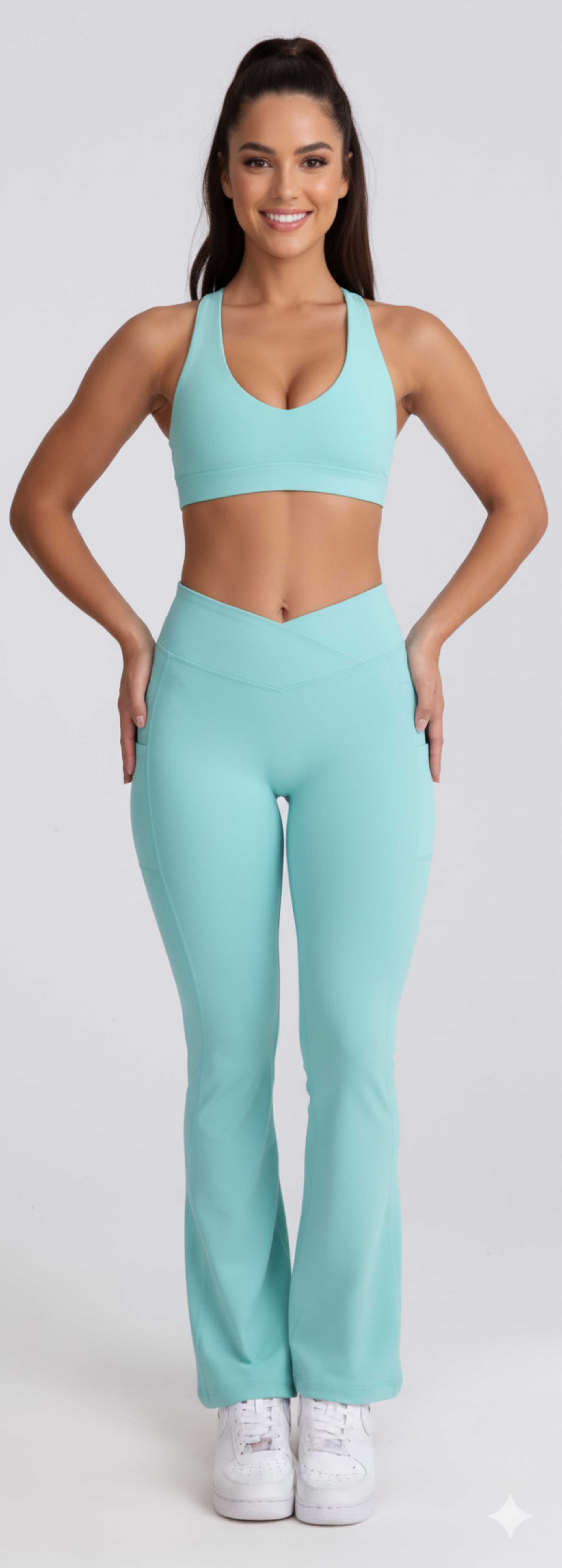 Woman wearing a matching Dew Flow fit flares in mint sports bra and leggings set on a white background