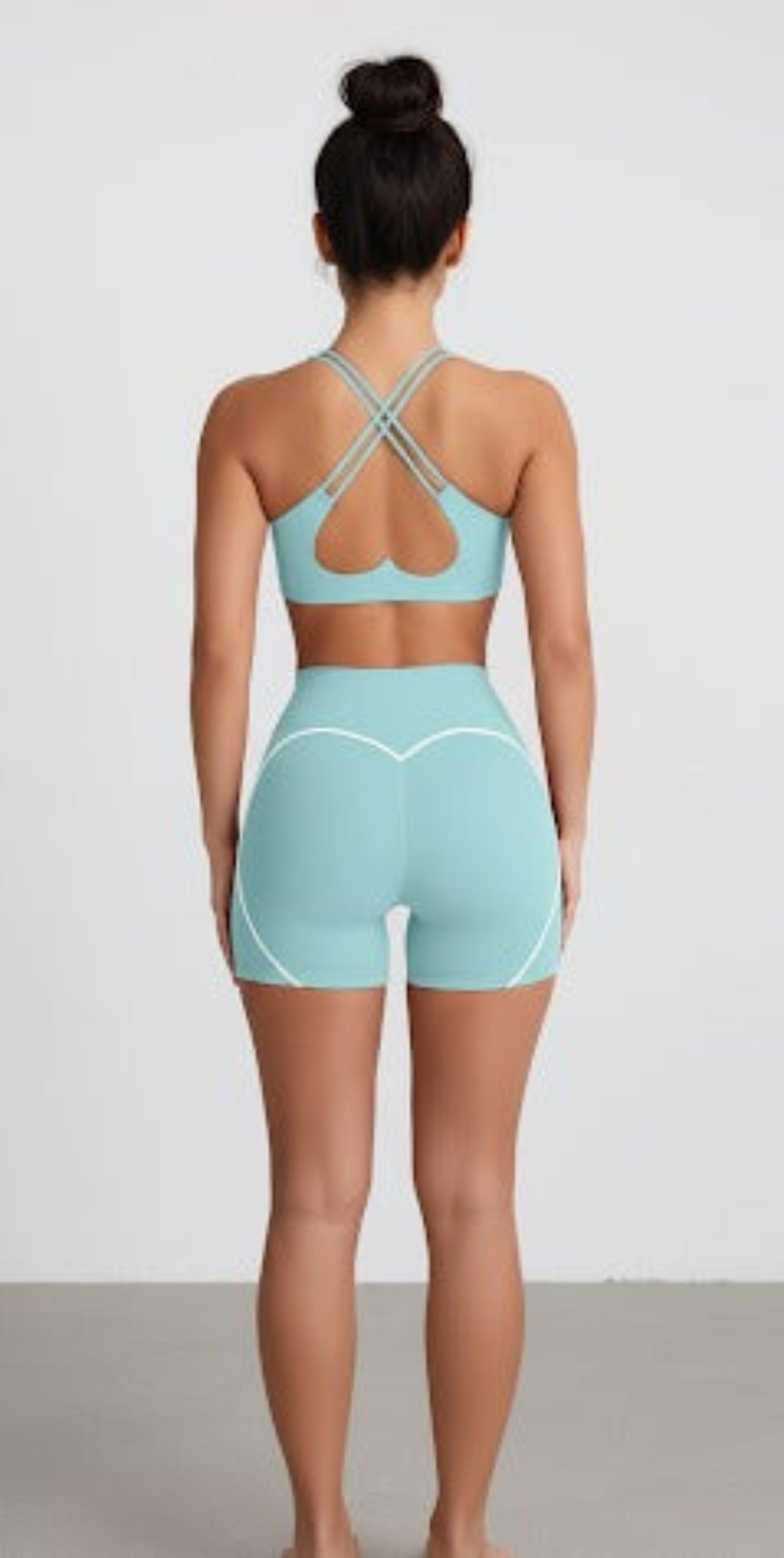 Person wearing a Dew Mint heart flex bra and shorts set on a white background