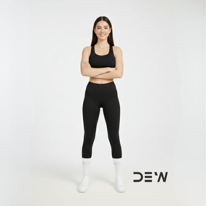 Woman wearing black athletic wear and Dew white crew socks with 'DEW' logo on a white background