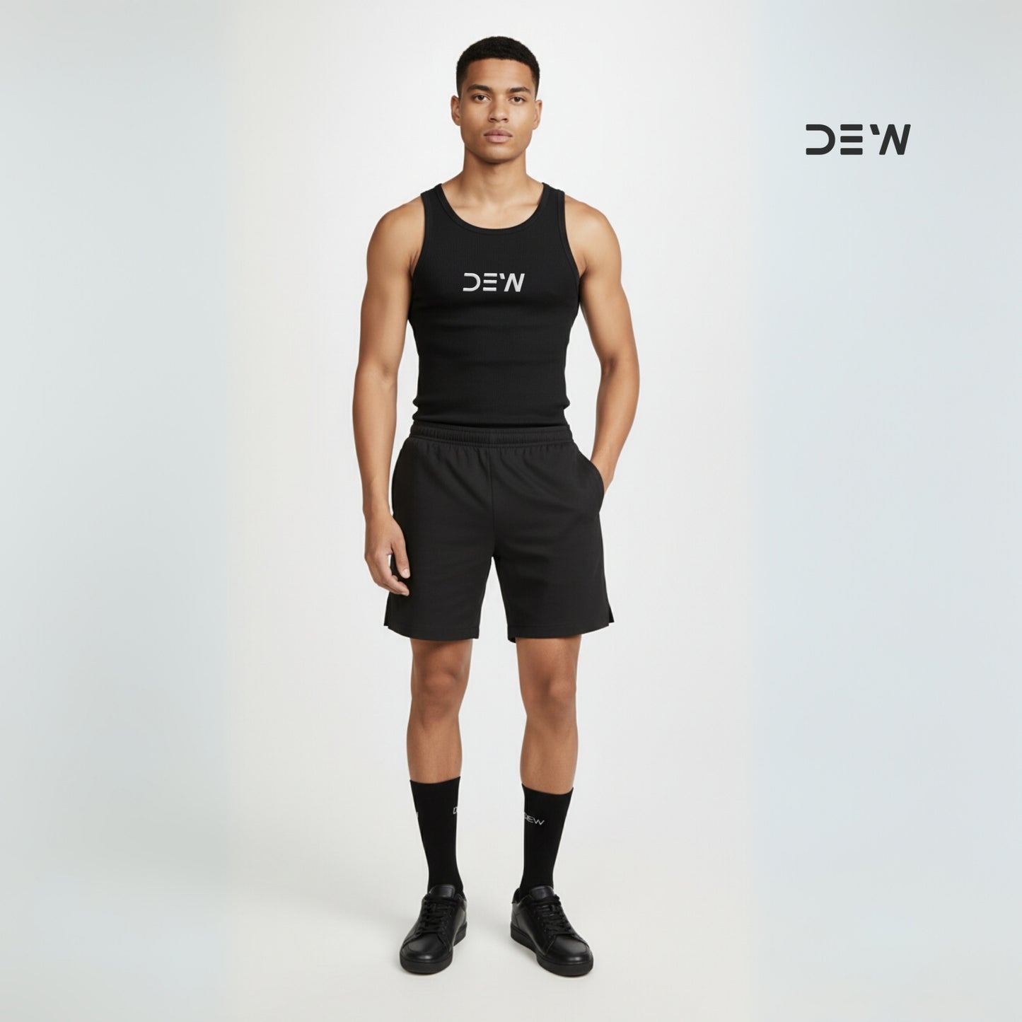 Person wearing a black tank top and shorts and Dew Crew socks
 with 'DEW' branding on a white background
