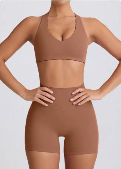 Person wearing a coco Dew heart flex bra and shorts set on a light gray background