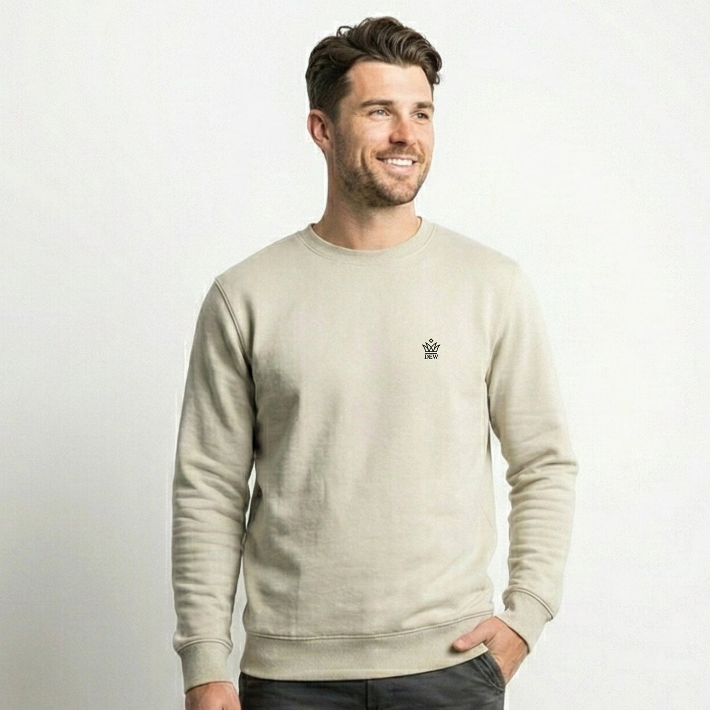 Man wearing a Dew cream crewneck jumper with a small embroidered dew logo on a white background