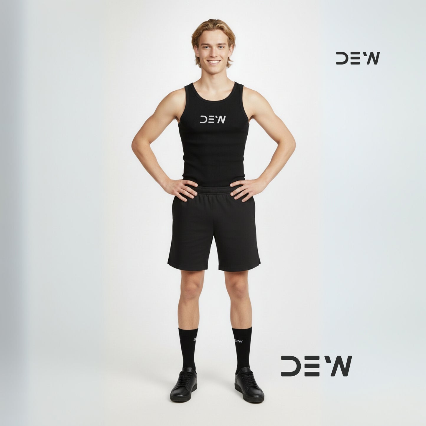 Person wearing a black tank top and shorts and Dew black crew socks with 'DEW' branding on a light gray background.