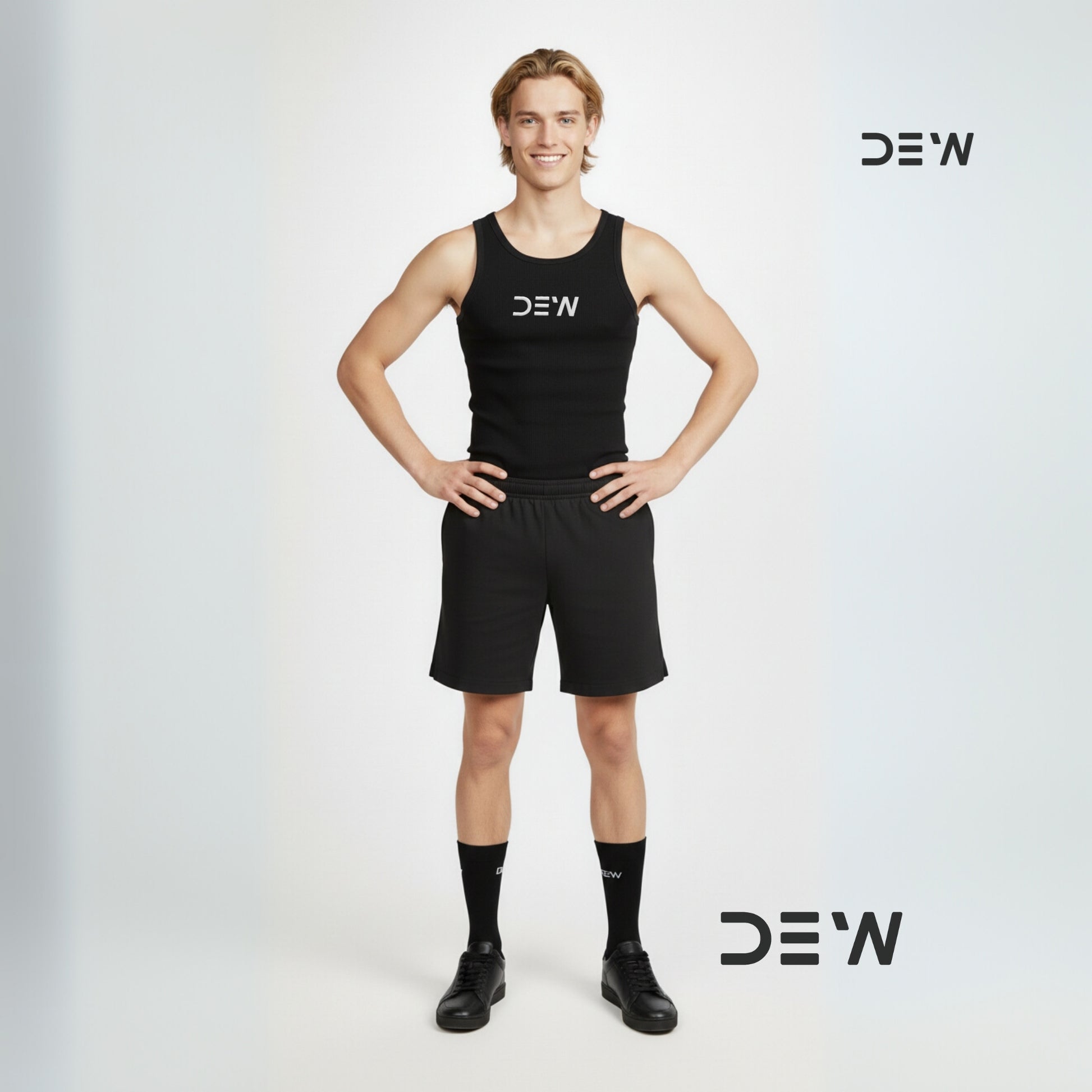 Person wearing a black tank top and shorts and Dew black crew socks with 'DEW' branding on a light gray background.