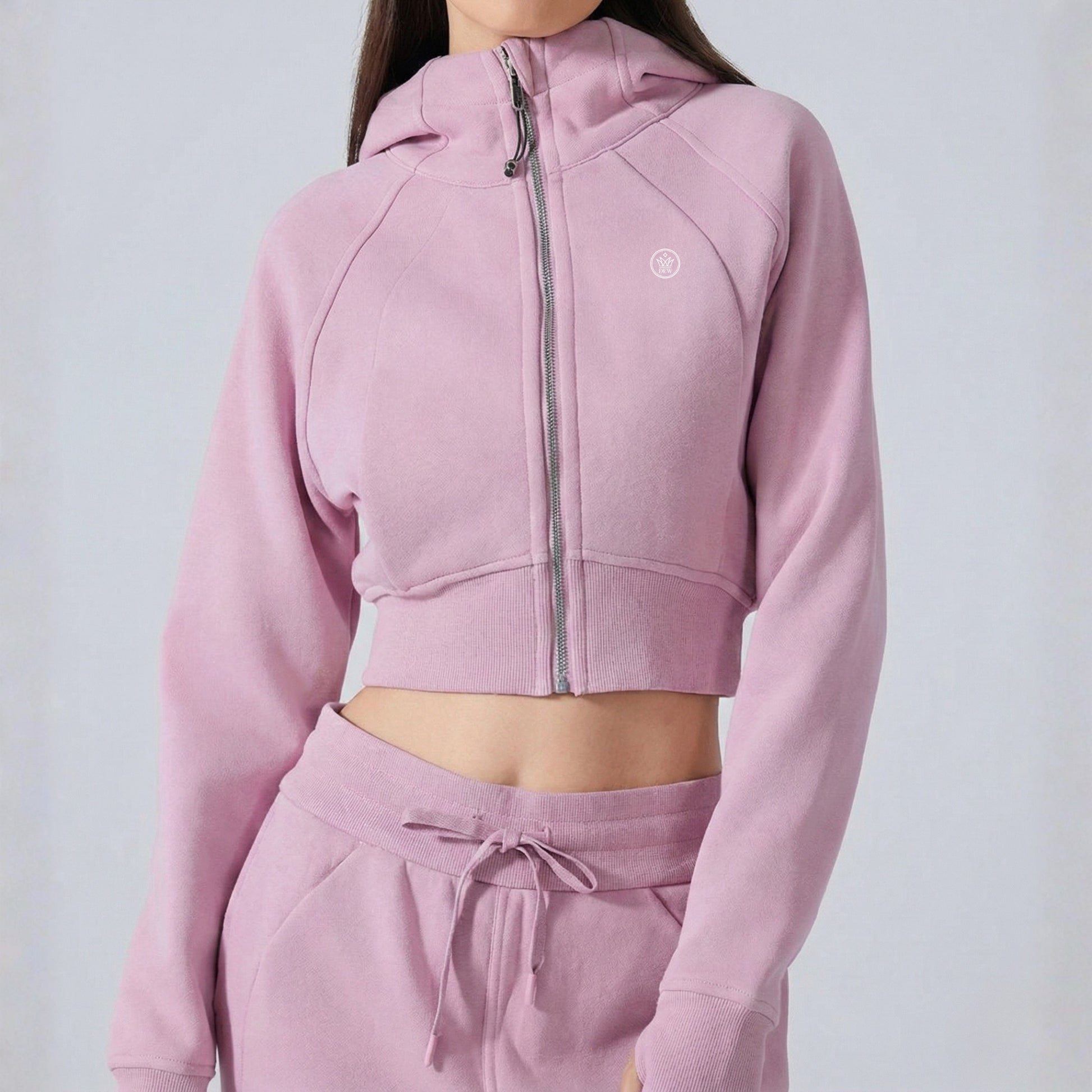 woman wearing Dew crop zip jacket in pink