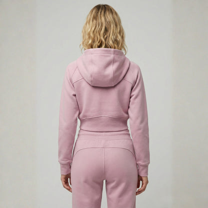 Woman wearing Dew crop zip jacket in pink back view