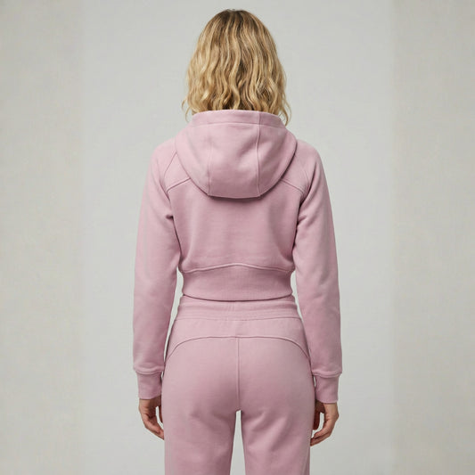 Woman wearing Dew crop zip jacket in pink back view