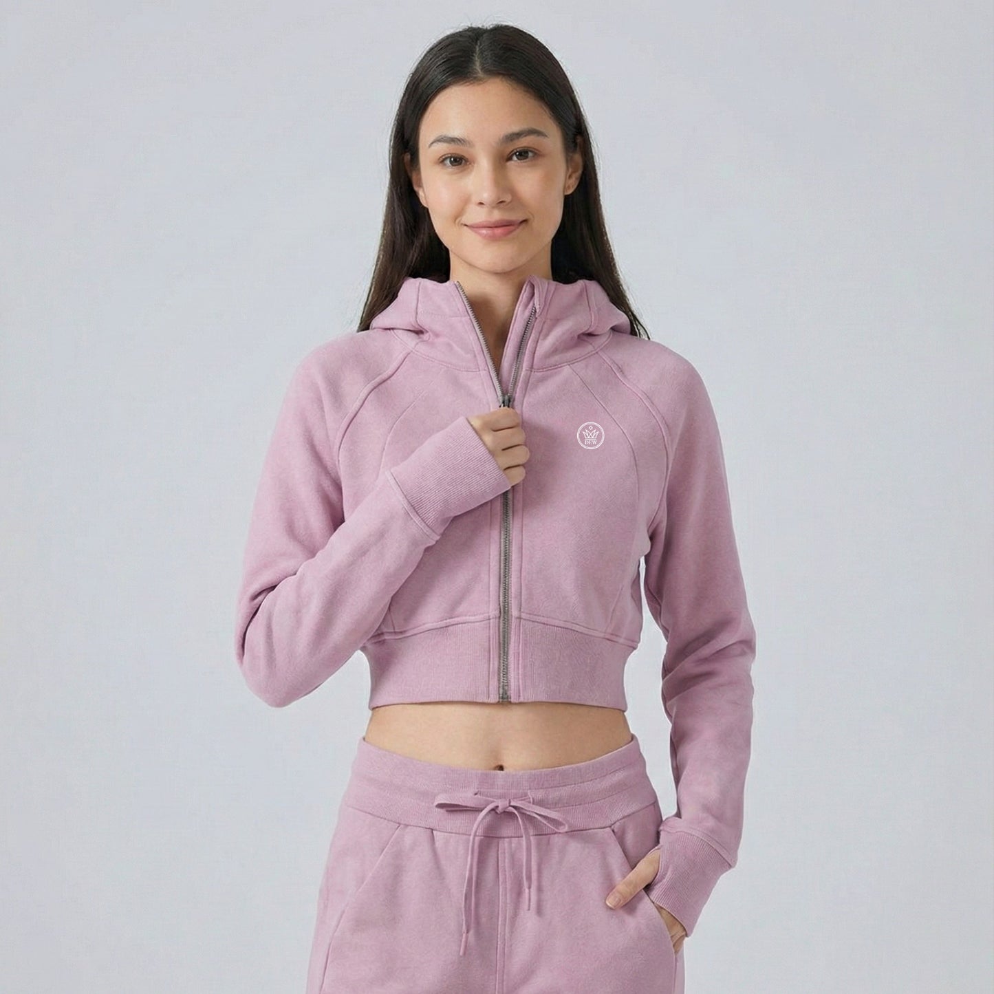 Woman wearing pink Dew crop zip jacket 