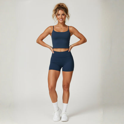 Woman wearing a Dew lux cami black  athletic outfit on a white background