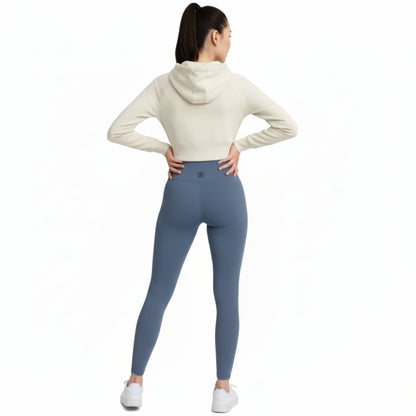 Person wearing a white hoodie and Dew ocean mist leggings on a white background