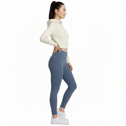 Woman wearing a cream hoodie and Dew ocean mist leggings on a white background