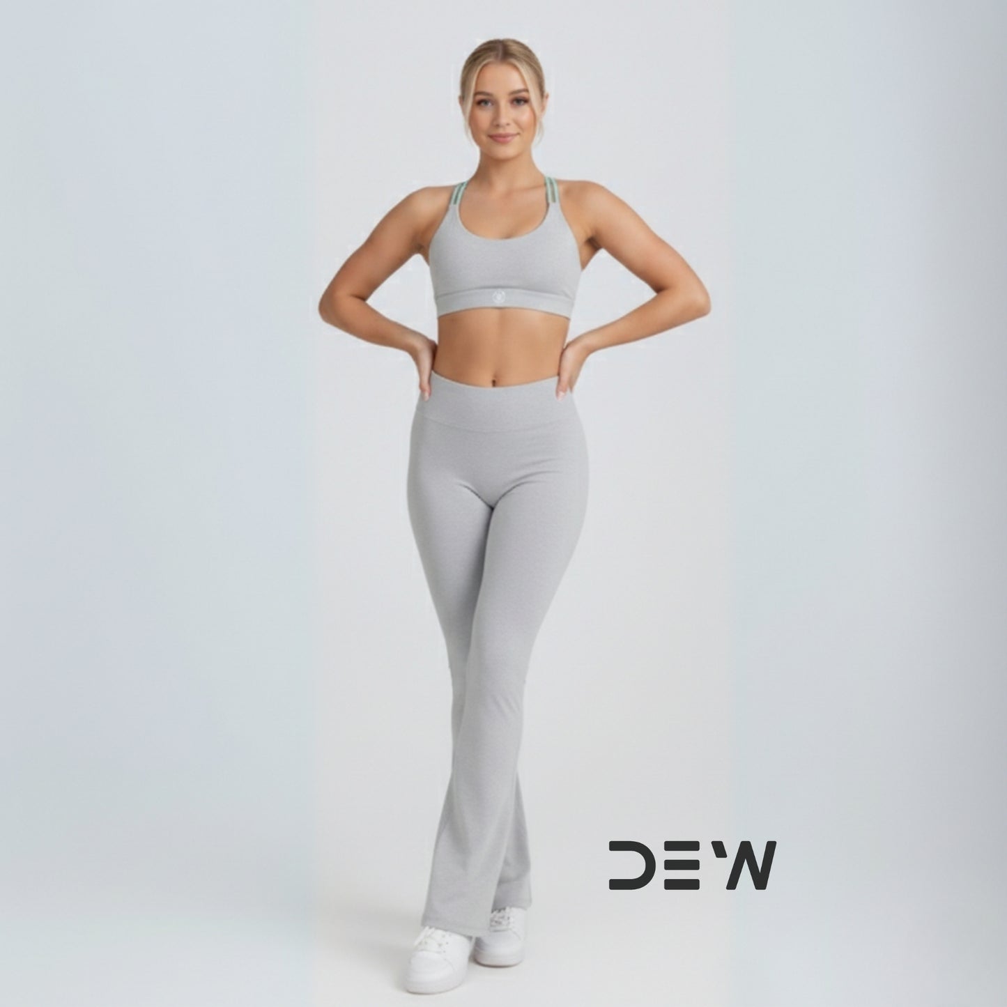 Australian woman wearing Grey Flow Fit Flare Leggings. Full-length view highlighting the bell-bottom cut and high-waist fit.