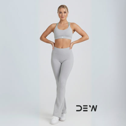 Australian woman wearing Grey Flow Fit Flare Leggings. Full-length view highlighting the bell-bottom cut and high-waist fit.
