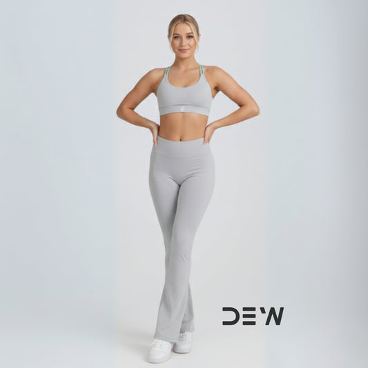 Australian woman wearing Grey Flow Fit Flare Leggings. Full-length view highlighting the bell-bottom cut and high-waist fit.