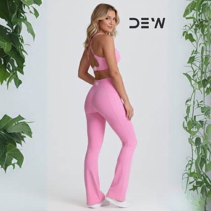 Woman wearing pink seamless sports bra and Flow Fit Flare leggings. Side profile showing high-waist fit and leg-lengthening flare design.